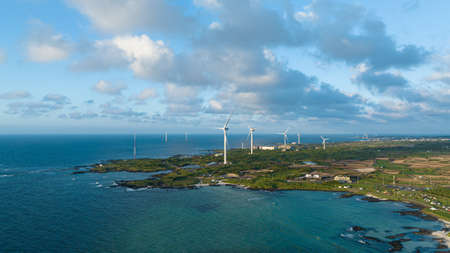 Beautiful sea landscape with fantastic clouds with a view of a wind turbineの写真素材
