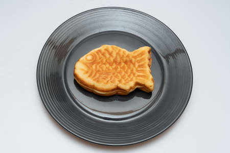 Sweet red bean bread in the shape of a crucian carp in a bowlの写真素材