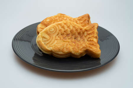Sweet red bean bread in the shape of a crucian carp in a bowlの写真素材