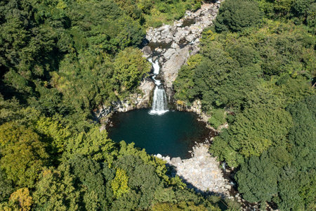 Beautiful view of Cheonjeyeon Falls in Jeju Island, South Korea, taken with a droneの写真素材