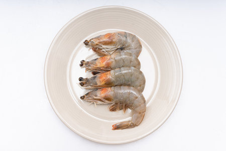 Fresh raw shrimp plated in a bowl on white backgroundの写真素材