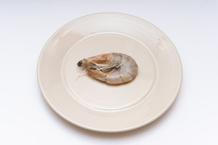 Fresh raw shrimp plated in a bowl on white backgroundの写真素材