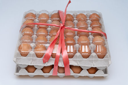 Bundle of 30 eggs tied with stringの写真素材