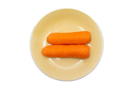 Fresh carrots in a bowl on a white backgroundの写真素材