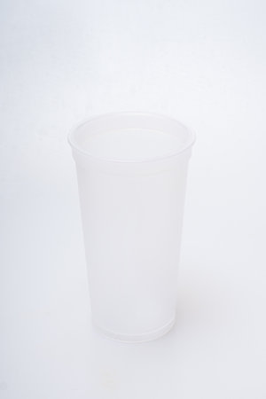 Reusable plastic water cup on a white backgroundの写真素材