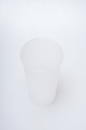 Reusable plastic water cup on a white backgroundの写真素材
