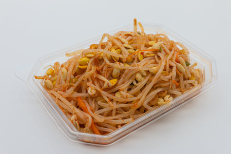 Thai spicy papaya salad in plastic box on white background.の写真素材