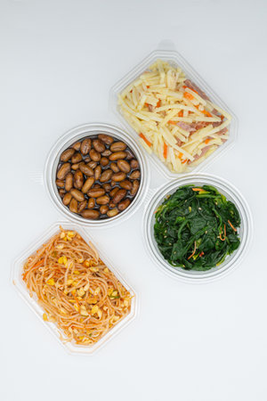 Plastic containers with different types of food on a white background.の写真素材