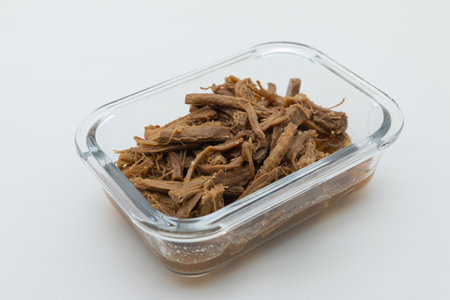 Canned beef in a glass bowl on a white background close upの写真素材