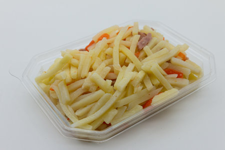 Fusilli pasta in a plastic container on a white background.の写真素材