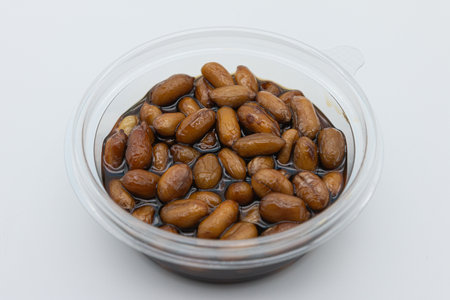 Preserved soybean in a plastic container on a white background.の写真素材