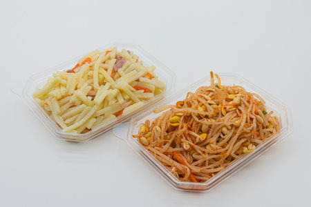 Papaya salad in plastic box on white background, Thai foodの写真素材