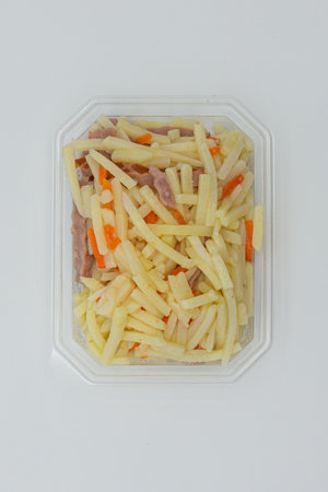 sauerkraut with carrots and ham in a plastic boxの写真素材