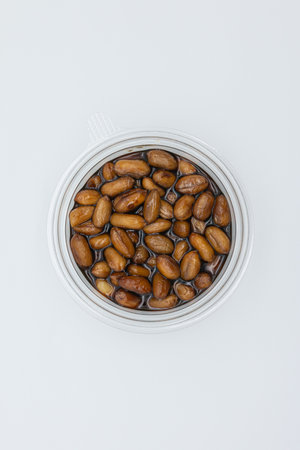 Coffee beans in a glass jar on a white background.の写真素材