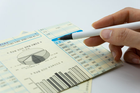 Businessman analyzing investment charts with a pen. Accounting and financial concept.の写真素材