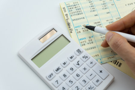 Calculator and financial statement on white background with copy space.の写真素材
