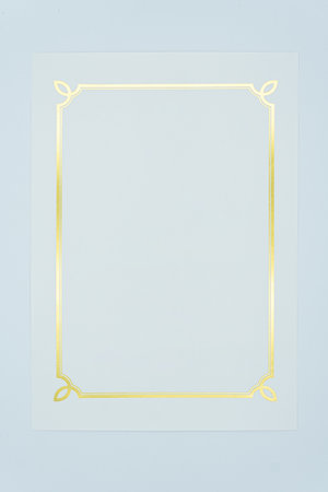 golden frame on blue paper background with copy space for text or imageの写真素材