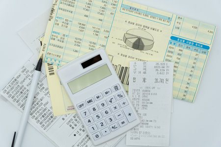 calculator and stationery on the table with financial documents.
