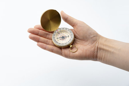 Compass in hand on a white background. Close-up.の写真素材