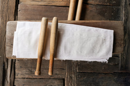 Wooden chopsticks and white napkin on rustic wooden backgroundの写真素材