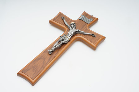 Wooden cross with Jesus Christ on a white background, isolated.の写真素材