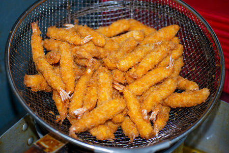 Various kinds of delicious-looking tempura fried in high-temperature oilの写真素材