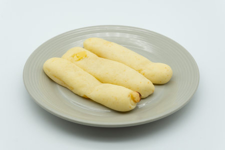 Crispy bread stick on a plate isolated on white background.の写真素材