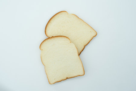 Slices of bread on a white background, top view.の写真素材