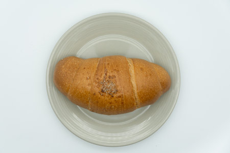 Croissant on a white plate isolated on a white background.の写真素材