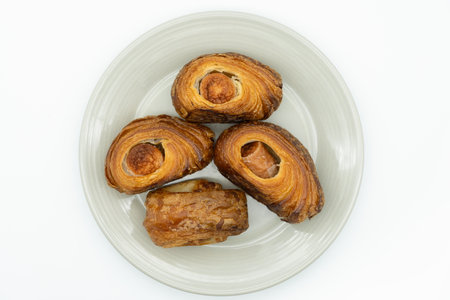 Baked buns on a plate isolated on a white background.の写真素材