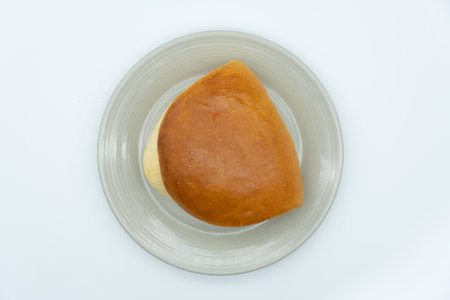 Bread with butter on white dish isolated on white background, top viewの写真素材