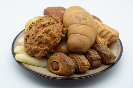Croissants and cookies on a plate isolated on white background.の写真素材