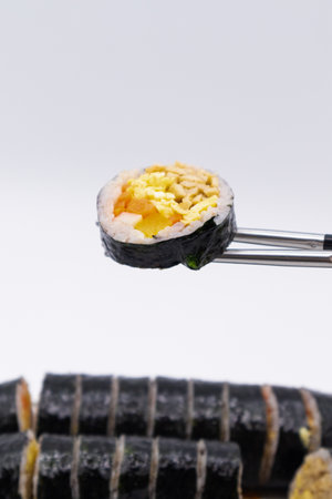Sushi on a fork isolated on white background. Close up.の写真素材