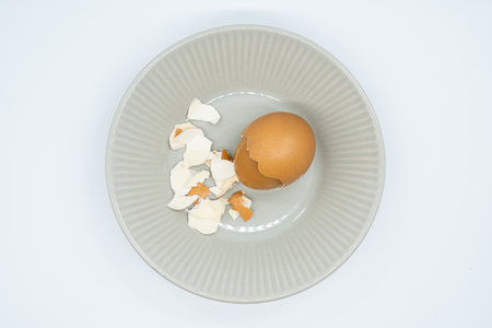 Boiled egg in a plate on a white background, top viewの写真素材