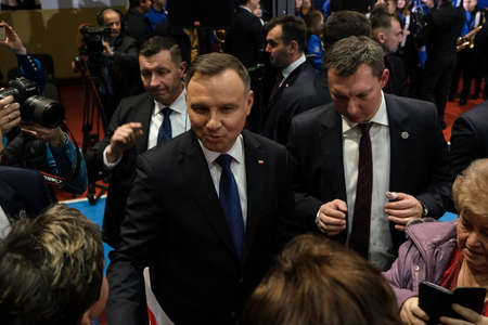 Wloszczowa, Poland - 06 February 2020: portrait of the Polish President Andrzej Duda on the background of Polish white and red flags, at the meeting with votersのeditorial素材