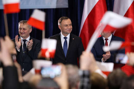 Wloszczowa, Poland - 06 February 2020: portrait of the Polish President Andrzej Duda on the background of Polish white and red flags, at the meeting with votersのeditorial素材