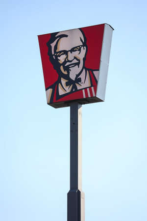 Czestochowa, Poland - 17 March 2020: KFC Logo And Sign Or Signboard On Advertising Column Against Blue Sky. KFC Is American Fast Food Restaurant Chain That Specializes In Fried Chickenのeditorial素材
