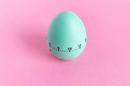 green egg timer on pink background. Happy Easter in the kitchen. Home related, home staying. Free...