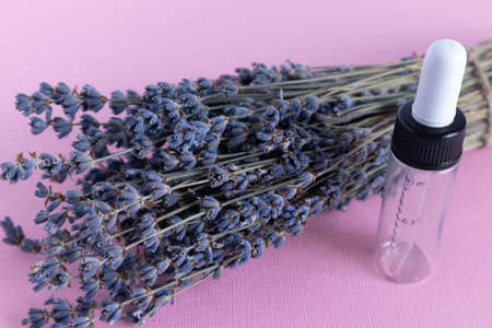 Lavender oils serum lavender flowers on pink. Skincare cosmetics products. Set natural spa beauty products. Lavender essential oil, serum, body butter, massage oil, liquidの写真素材