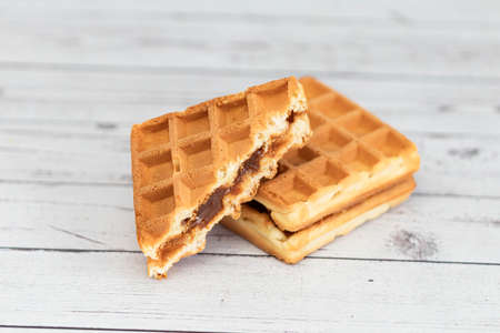 Belgian waffles close up isolated on white background. Delicious, fresh baked goodsの写真素材
