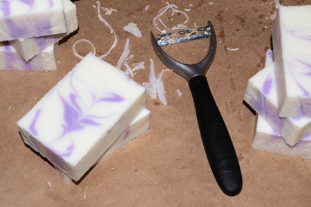 Close-up of some bars of freshly made natural handmade soap with lavender essential oil. Tool for making soapの写真素材