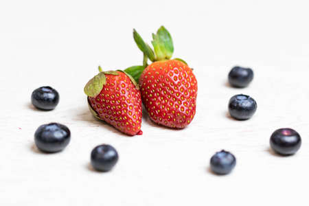 Ripe and juicy strawberries and blueberries on a white background. Healthy eatingの写真素材