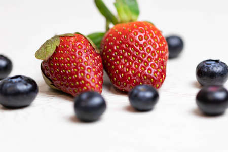 Ripe and juicy strawberries and blueberries on a white background. Healthy eatingの写真素材