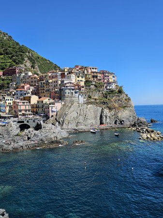 Vertical photo with copy space of Manarola. Village on the cliffs of the Ligurian Sea.