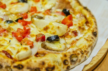 The Italiano Pizza consisting of salami,mushroom,bacon,black olives,melted cheese and capsicum.の写真素材