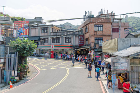 JiufenTaiwan  March 18 2015: Tourists can seen walking through the entrance of Jiufen old street along the street there are shops vending the most famous country snack and various local accessories.のeditorial素材