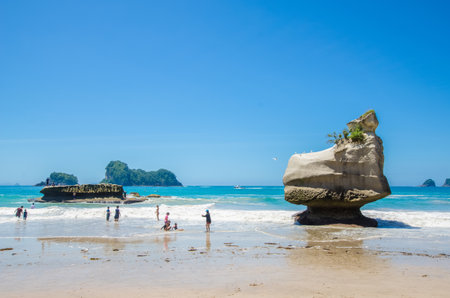Coromandel,New Zealand - January 24, 2016: Cathedral Cove in Coromandel Peninsula on the North Island of New Zealand. People can seen exploring around it.のeditorial素材