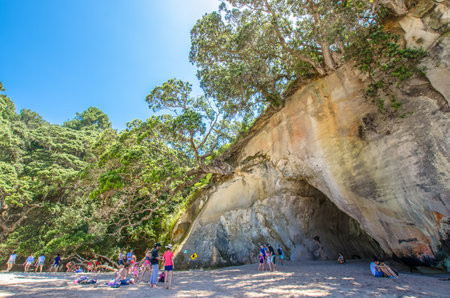 Coromandel,New Zealand - January 24, 2016: Cathedral Cove in Coromandel Peninsula on the North Island of New Zealand. People can seen exploring around it.のeditorial素材