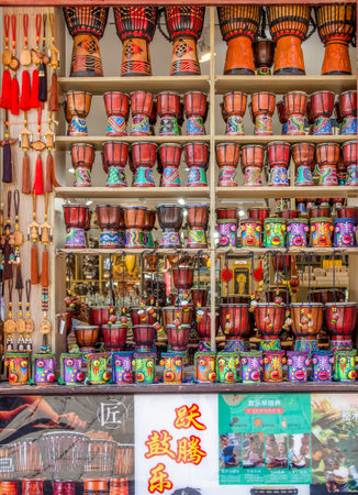 Kunming,China - April 9,2017 : Souvenirs and djembe selling in the retail which is located at the Yunnan Nationalities Village,Chinaのeditorial素材