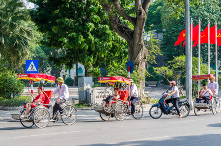 Hanoi,Vietnam - November 2,2017 : Tourists taking a tour to exploring around Hanoi with Vietnamese trishaw.のeditorial素材